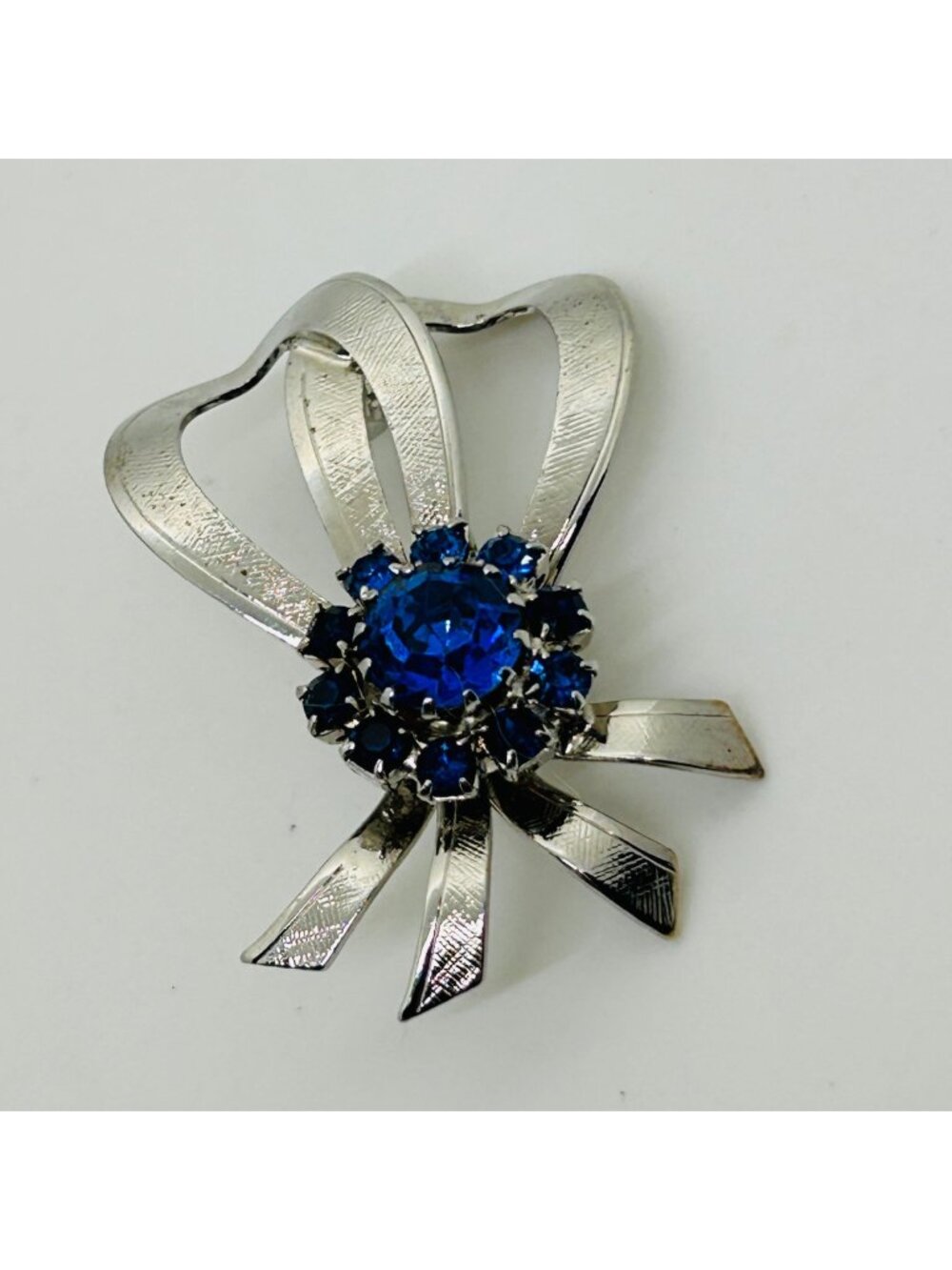 Blue Rhinestone Ribbon Bow Pin Textured Silver Tone Cluster Openwork Vintage